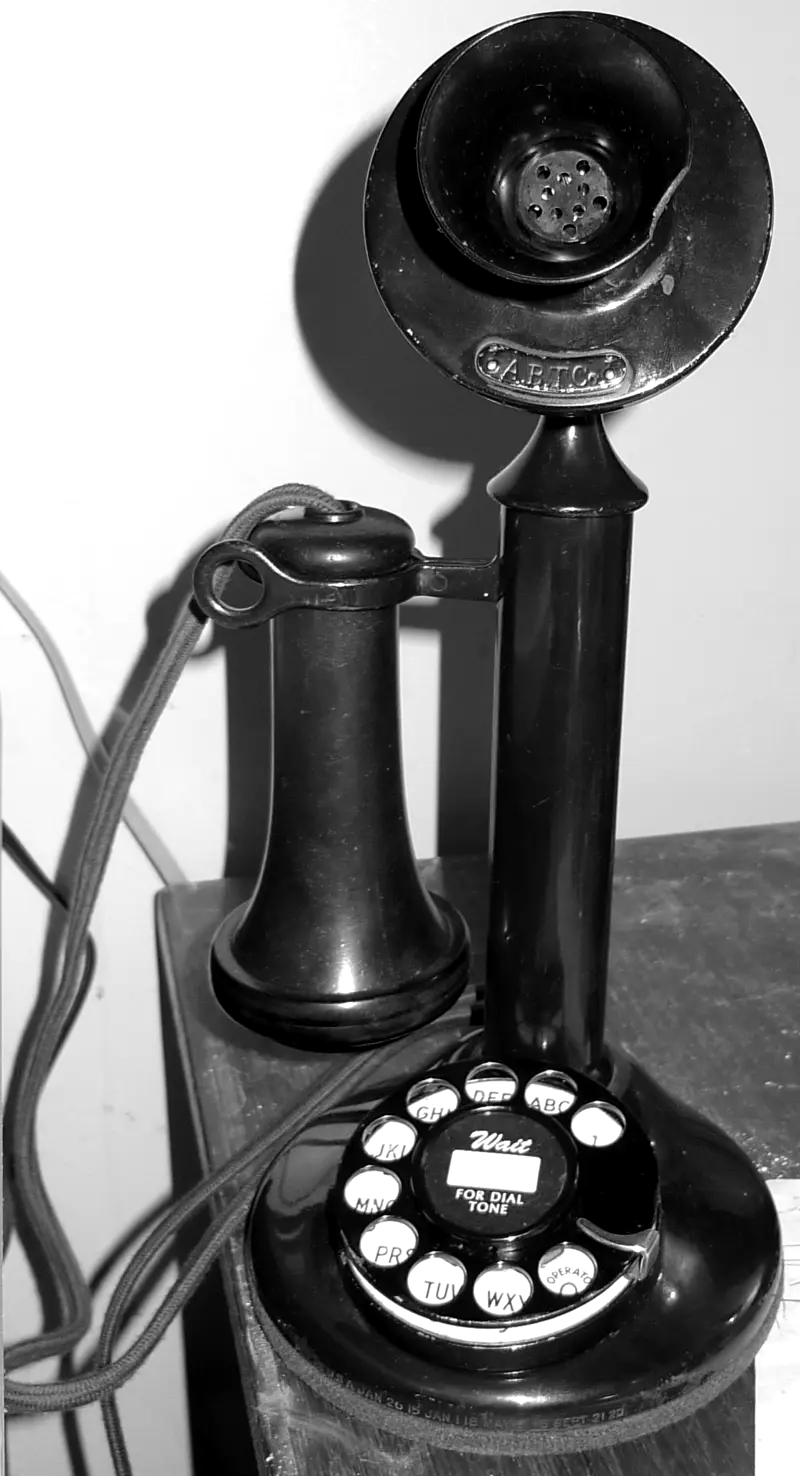 Staande zwarte telefoon met draaischijf en losse hoorn